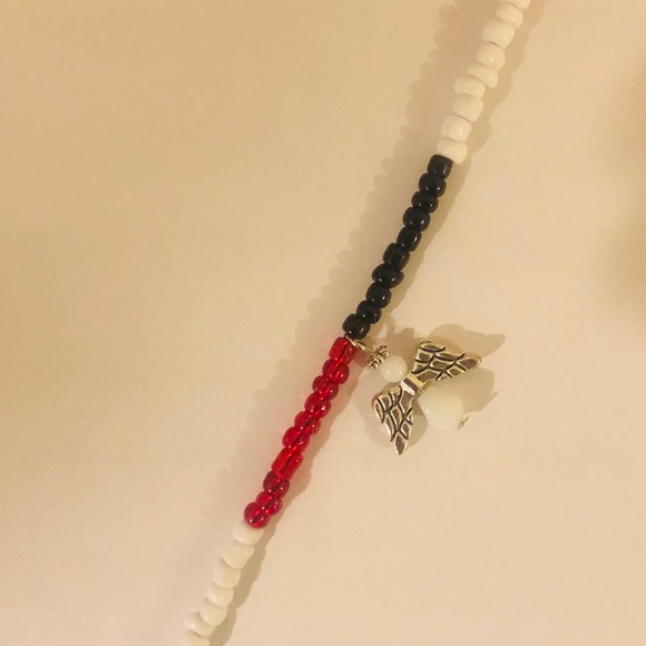 Red/White/Black beaded bracelet w/ an angel charm. - Picture 2 of 2